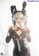 A woman in a black and white bunny costume posing for a picture.