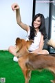 A woman sitting on the floor with a dog.