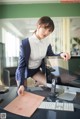 A woman sitting at a desk in front of a computer.