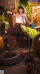 A woman sitting on top of a pile of tires.