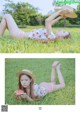 A woman laying on the grass eating a slice of watermelon.