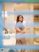 A woman standing in a bathroom next to a sink.