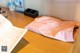 A pink paper bag sitting on top of a wooden table.