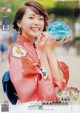 A woman in a pink kimono holding a bowl of ice cream.